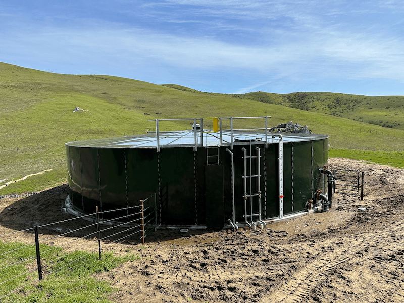 External photo of a large water tank on an agricultural property.